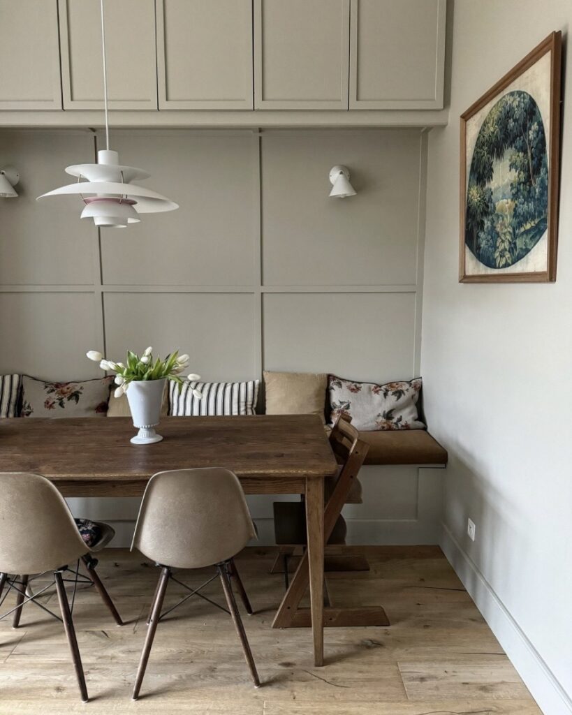 neutral dining room colour ideas with panelled walls wooden dining table and soft grey beige tones creating a calm modern space