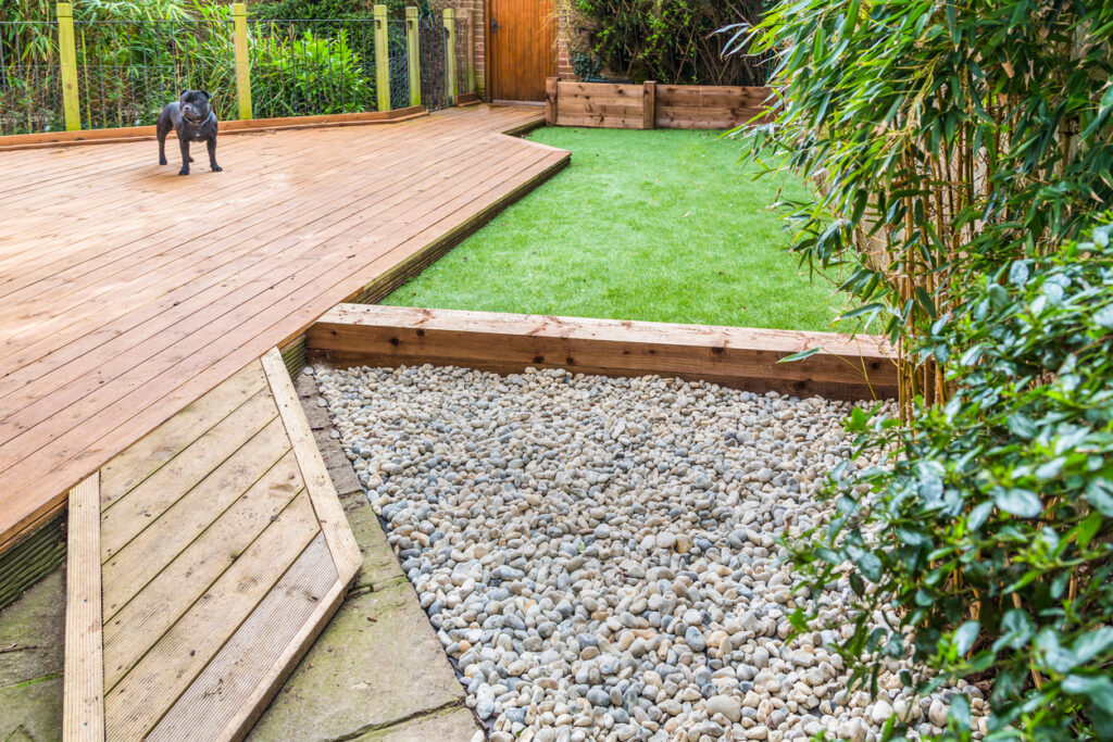 mixed material garden edging ideas with timber decking artificial grass and gravel border