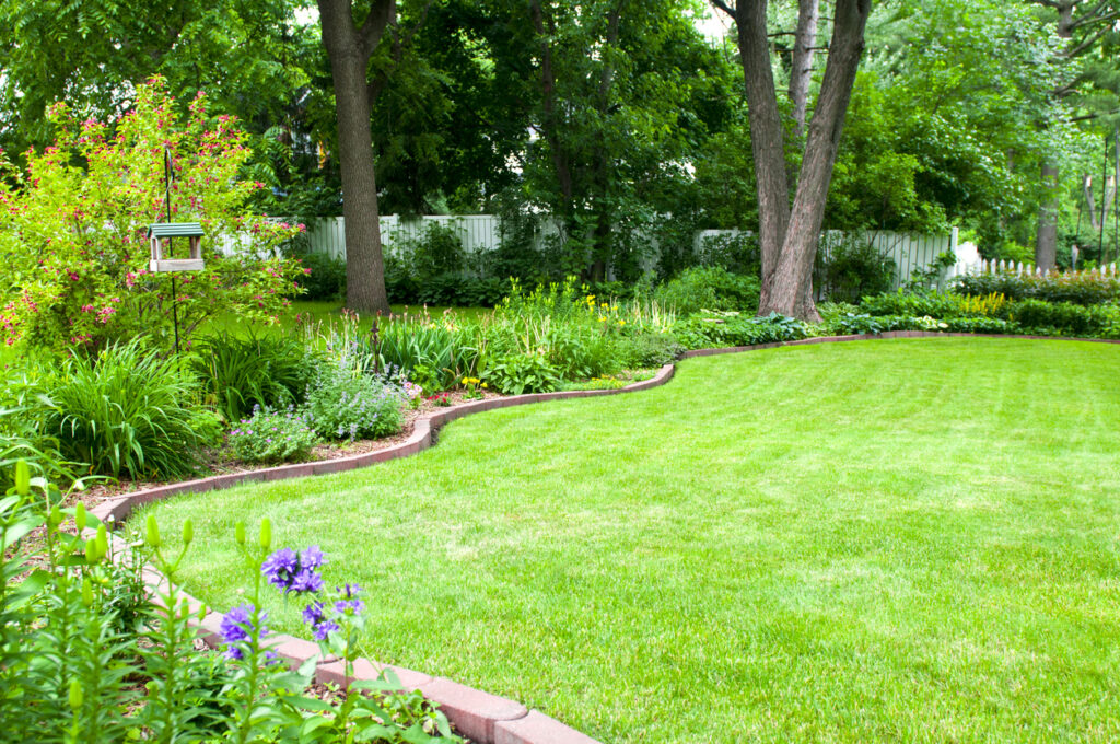 garden edging ideas with curved brick lawn border and planting beds