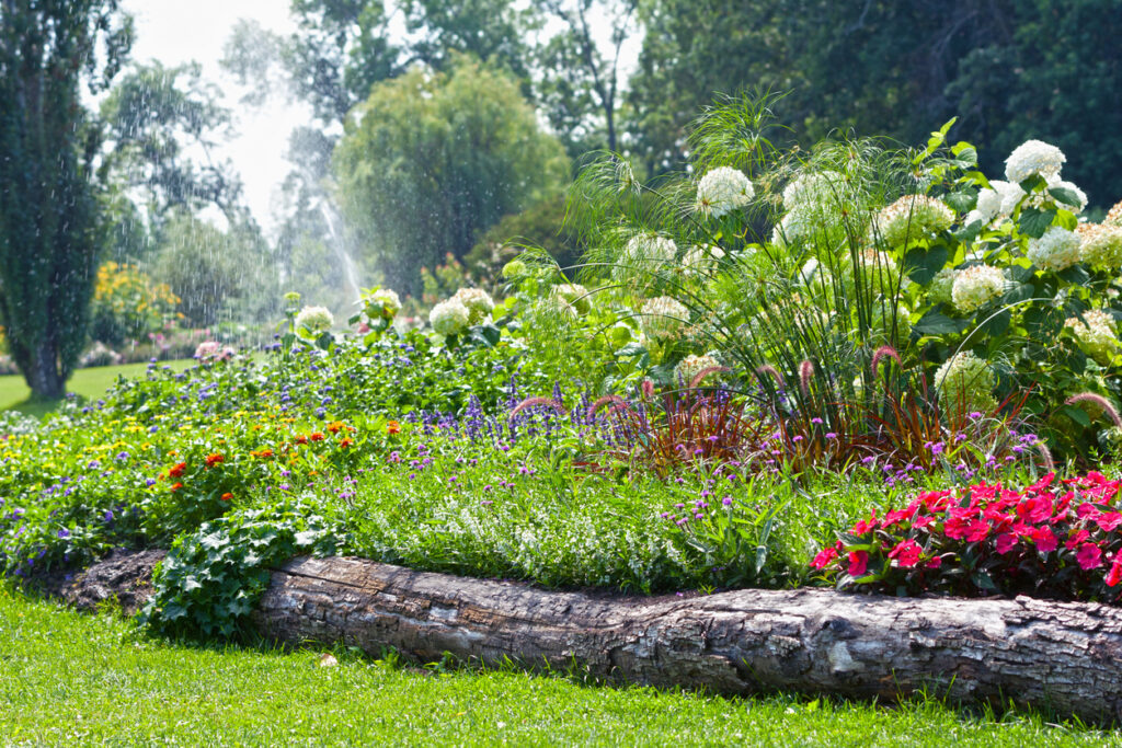 reclaimed wood garden edging using rustic log border between lawn and flower bed
