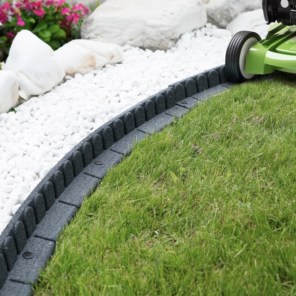lawn edging ideas with curved recycled rubber border between grass and white stones
