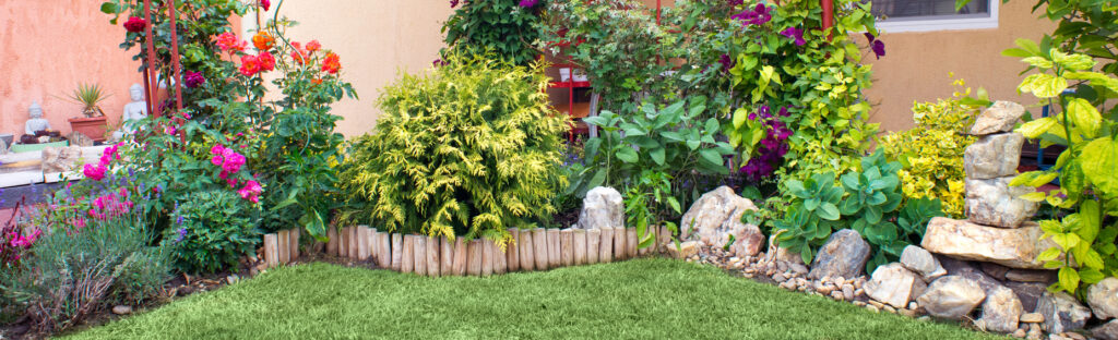 curved timber garden edging with planting border and lawn in ornamental garden
