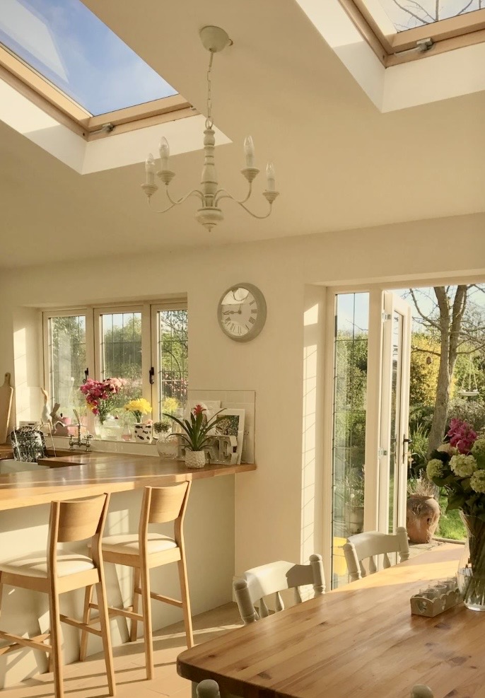 Wood and cream kitchen dining room ideas with Dimity walls, natural wood furniture and a light-filled kitchen diner