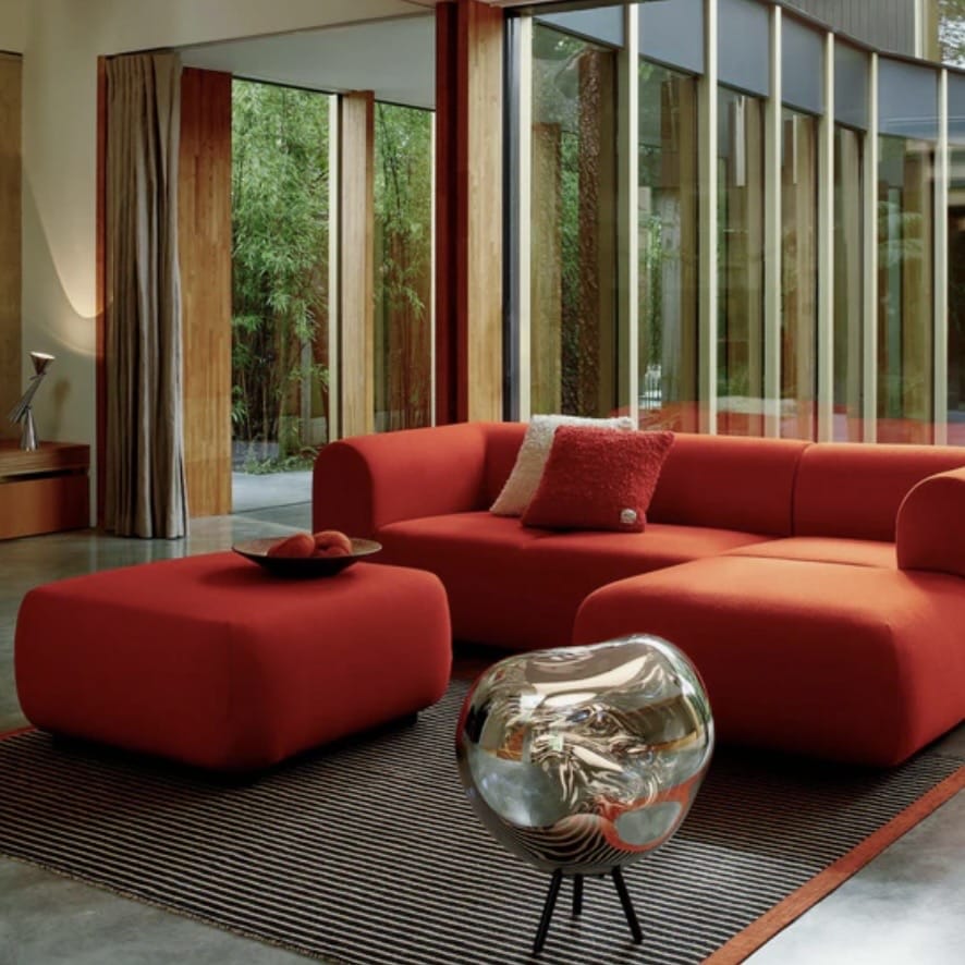 Orange living room with modern striped orange rug and bold orange sofa in contemporary space