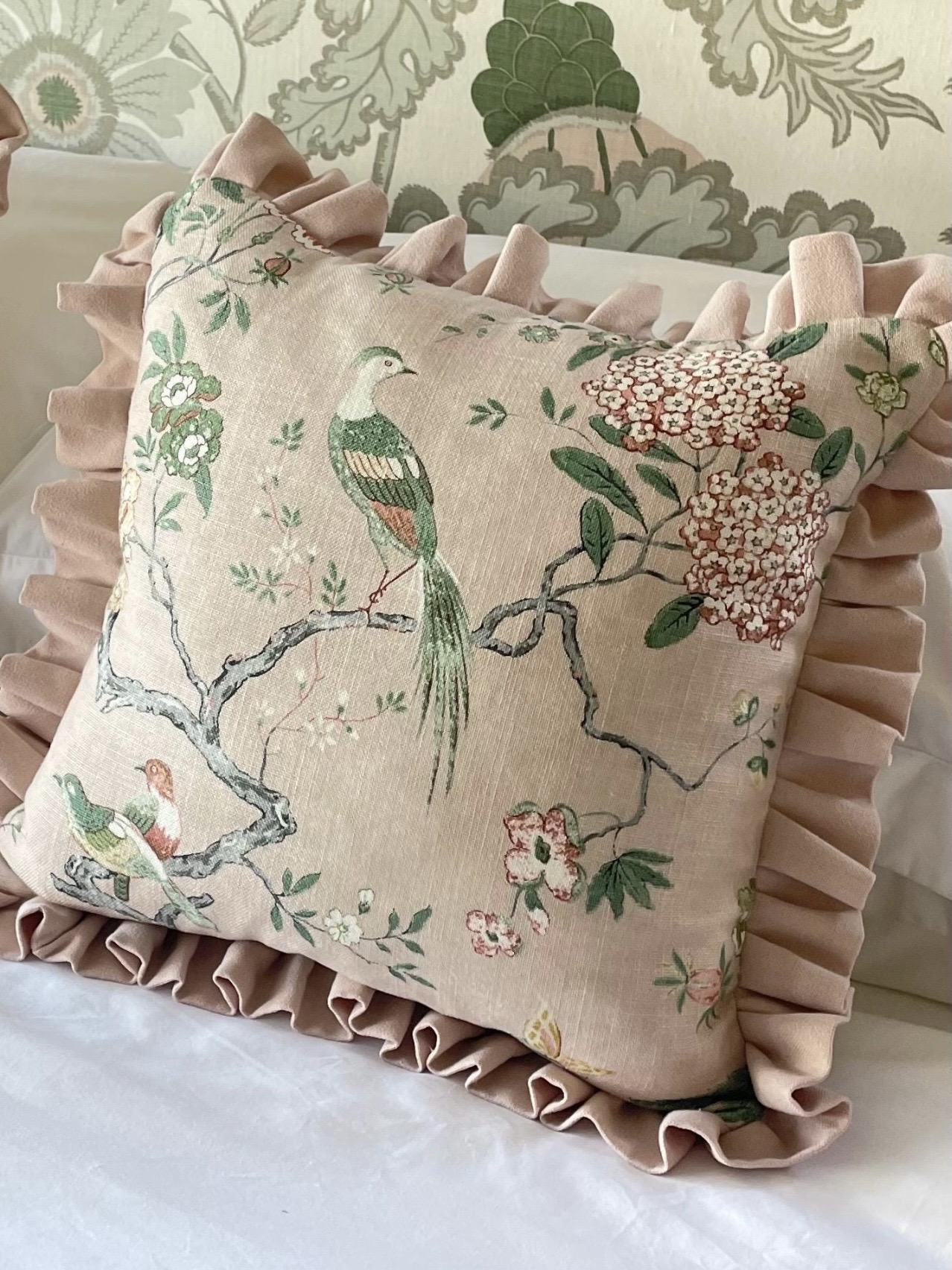 Pink and green cushions styled in a calm, playful living room