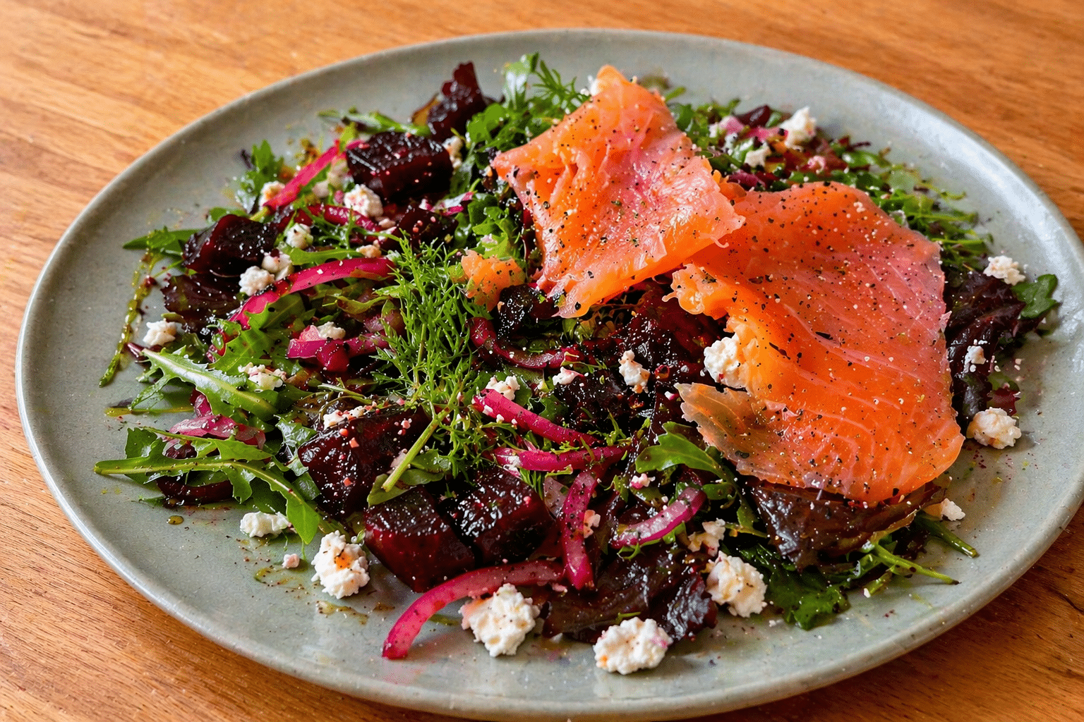 Beetroot and feta salad with smoked salmon served on a green plate, a vibrant beetroot salad recipe and smoked salmon salad idea
