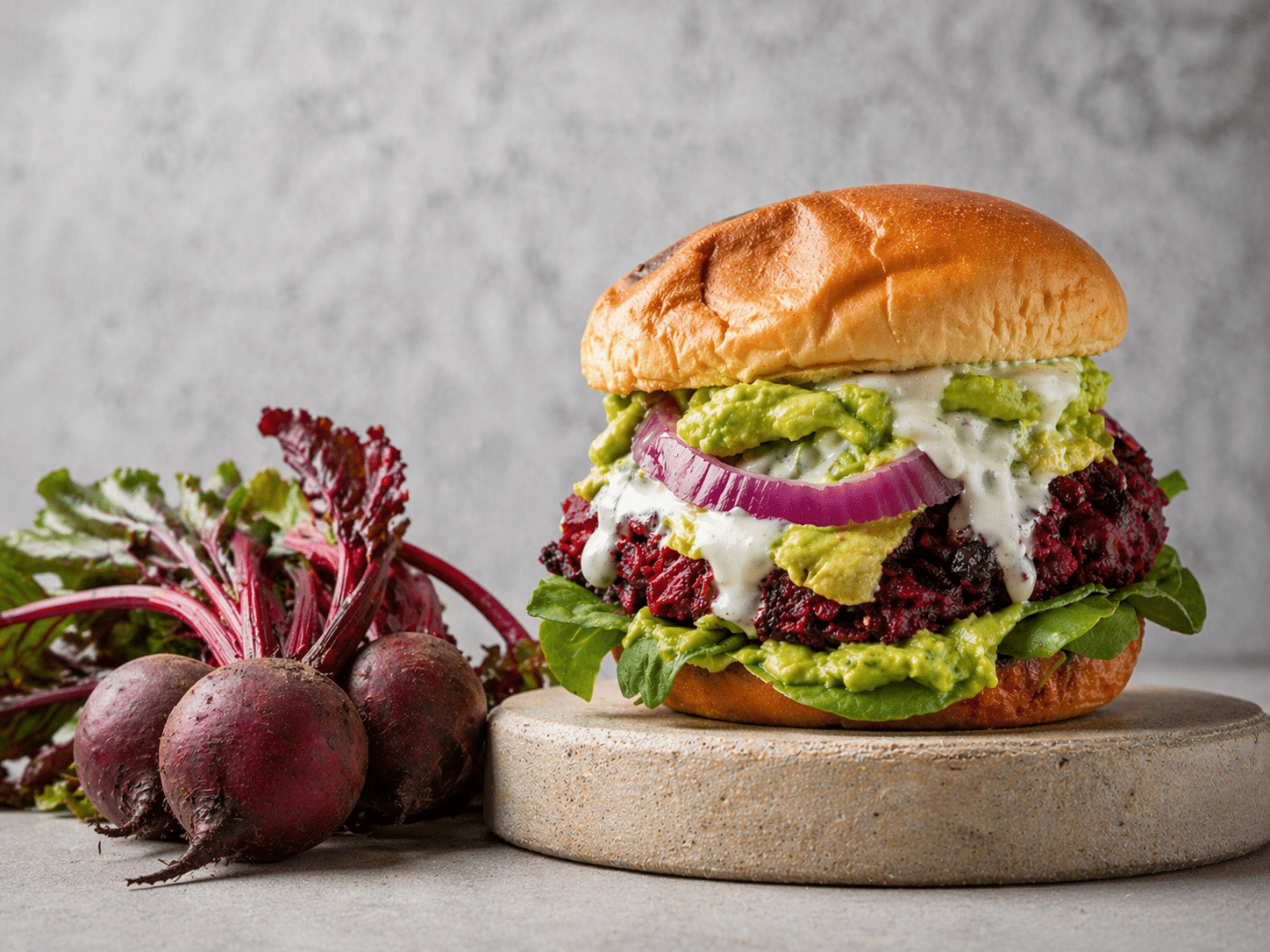 Beetroot burger recipe with avocado, red onion and kefir mint lemon sauce