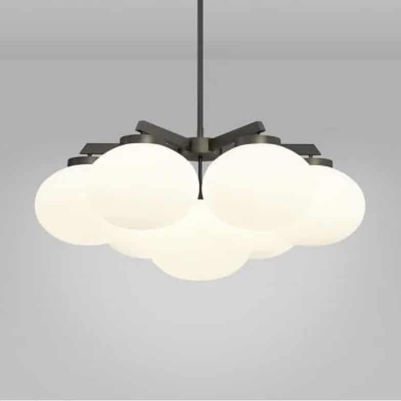 Bronze chandelier with matt opal glass globes for a beige and black bedroom