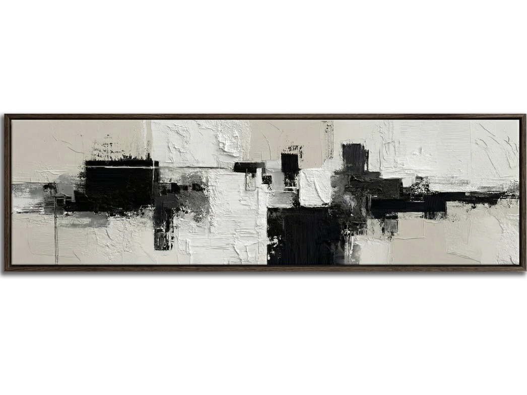 Black, white and beige panoramic abstract wall art above a bed