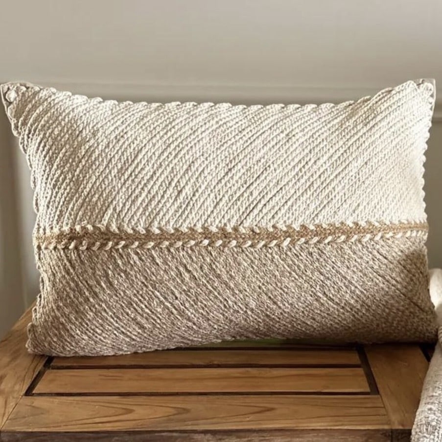 Jute braided lumbar cushion on a chic boho beige bed