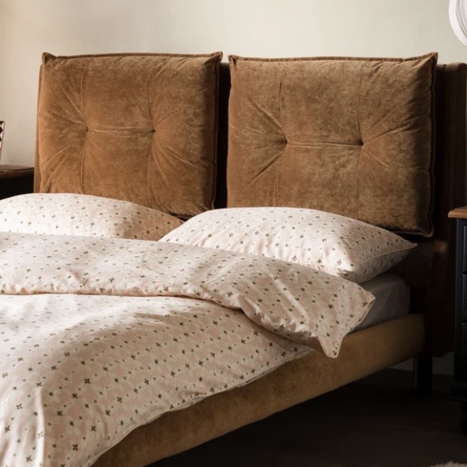 Bronze velvet bed in a luxury beige bedroom