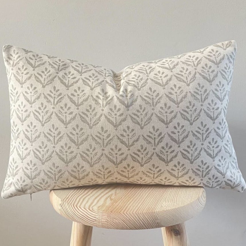 neutral leaf print cushion for a black and beige bedroom