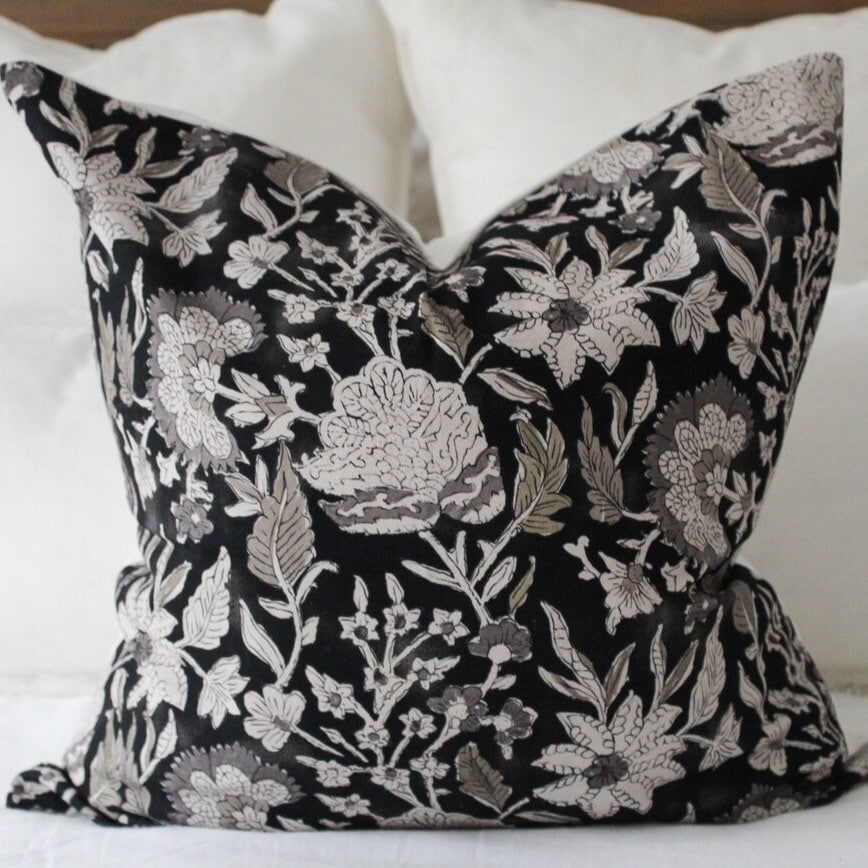 black floral cushion cover with cream botanical pattern for a black and beige bedroom