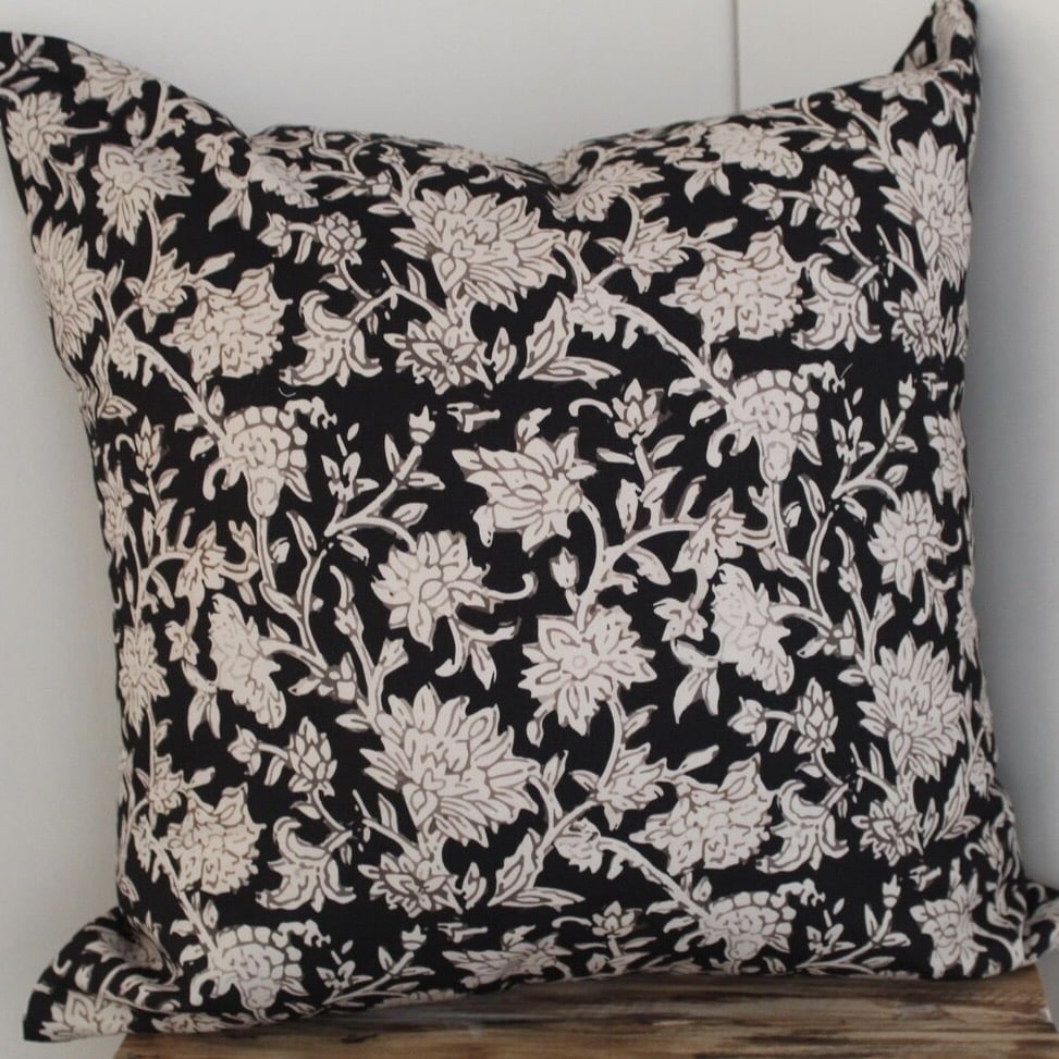 floral black And beige cushion cover on white bedding for a black and beige bedroom