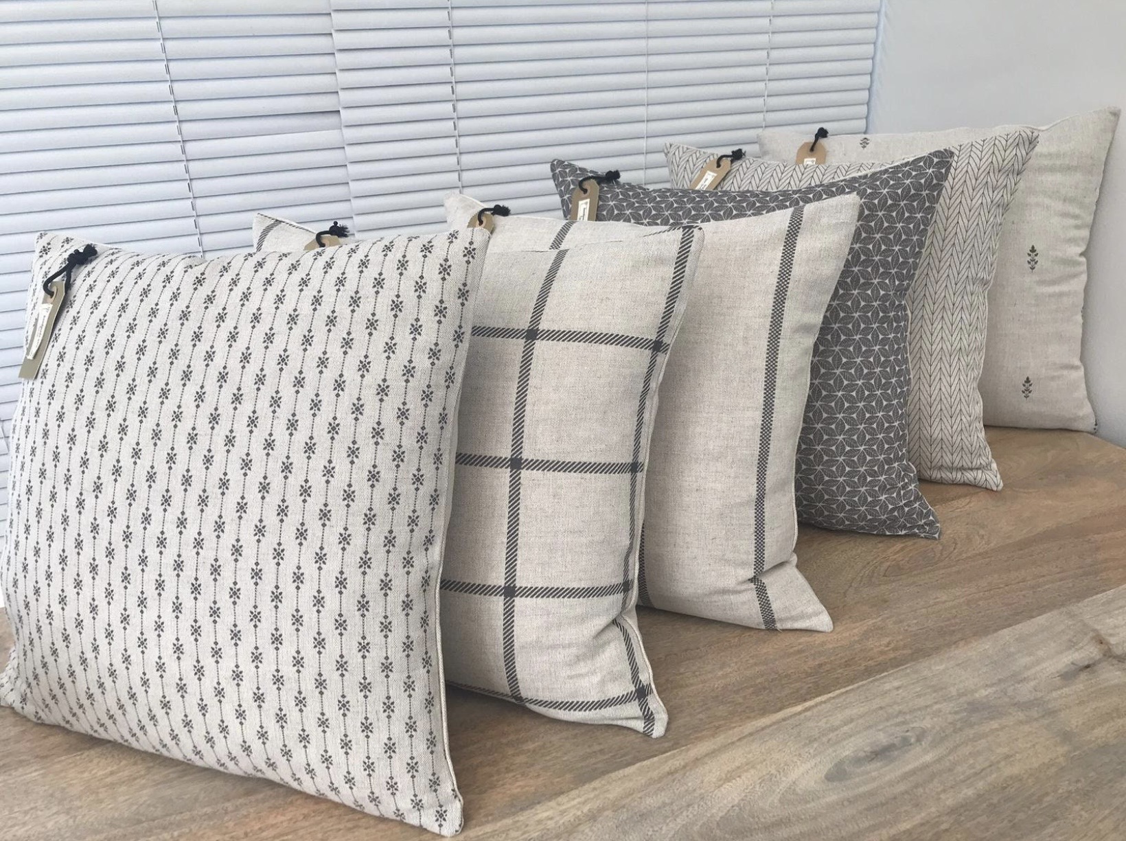 Understated black and beige cushion bundle with checks, stripes and small-scale patterns