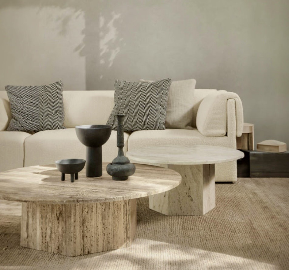 GUBI Epic Coffee Table styled in a beige sofa living room with sculptural objects, showing minimalist coffee table styling and modern coffee table décor ideas.