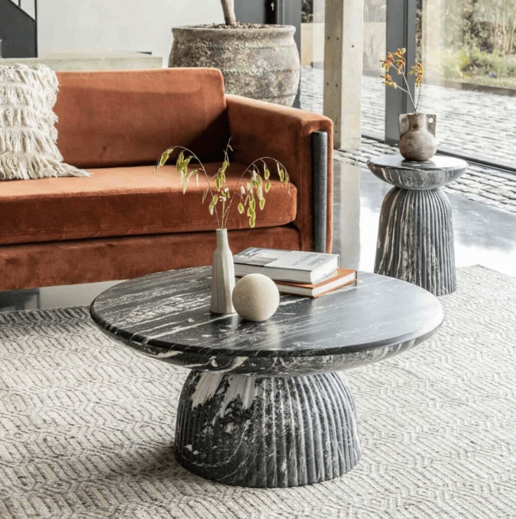 Mason Coffee Table styled in a modern living room with an orange sofa, unique side table, and sculptural coffee table styling for contemporary coffee table décor ideas.