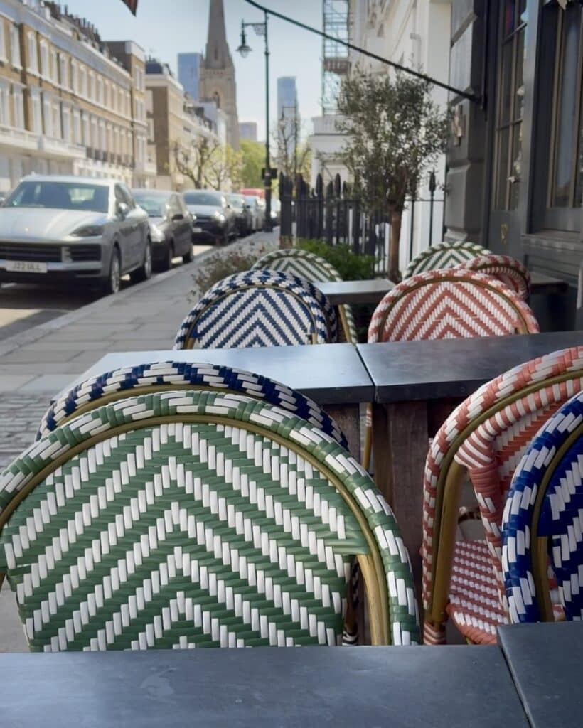 Colourful woven rattan bistro chairs on the terrace at Artists Residence London — eclectic home decor extends outdoors