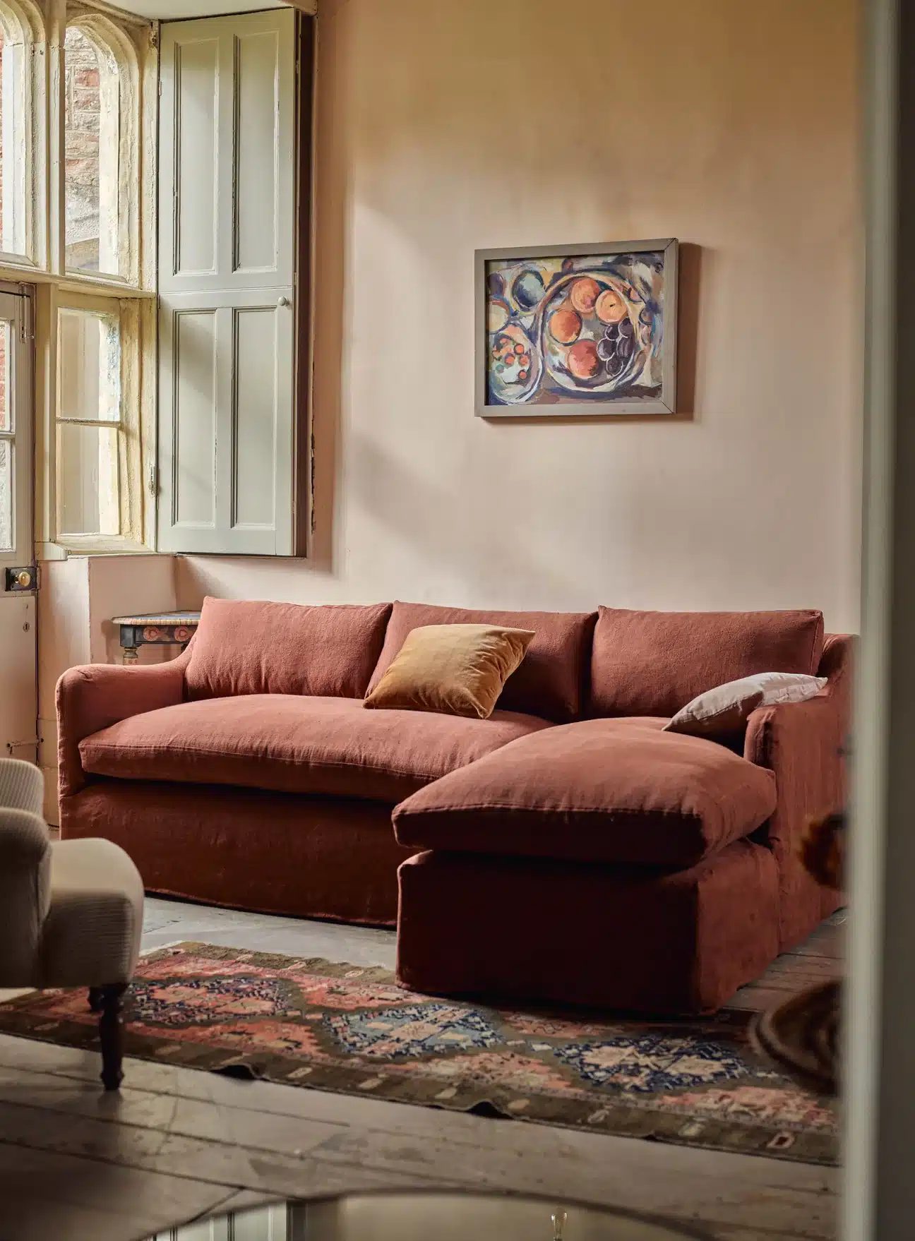 Burnt orange living room with textured cushions and warm autumn lighting