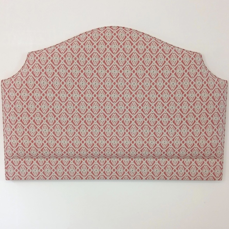 Rose pink ikat shaped headboard in a pink and green bedroom