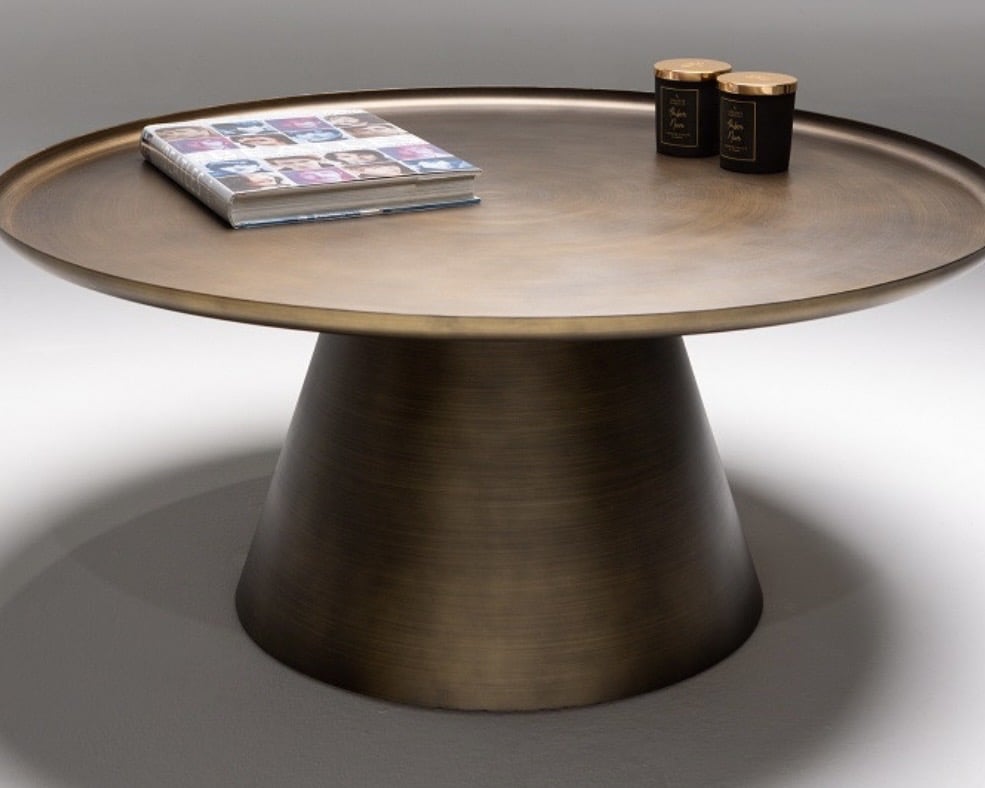 Antique bronze circular coffee table for a pink and green living room