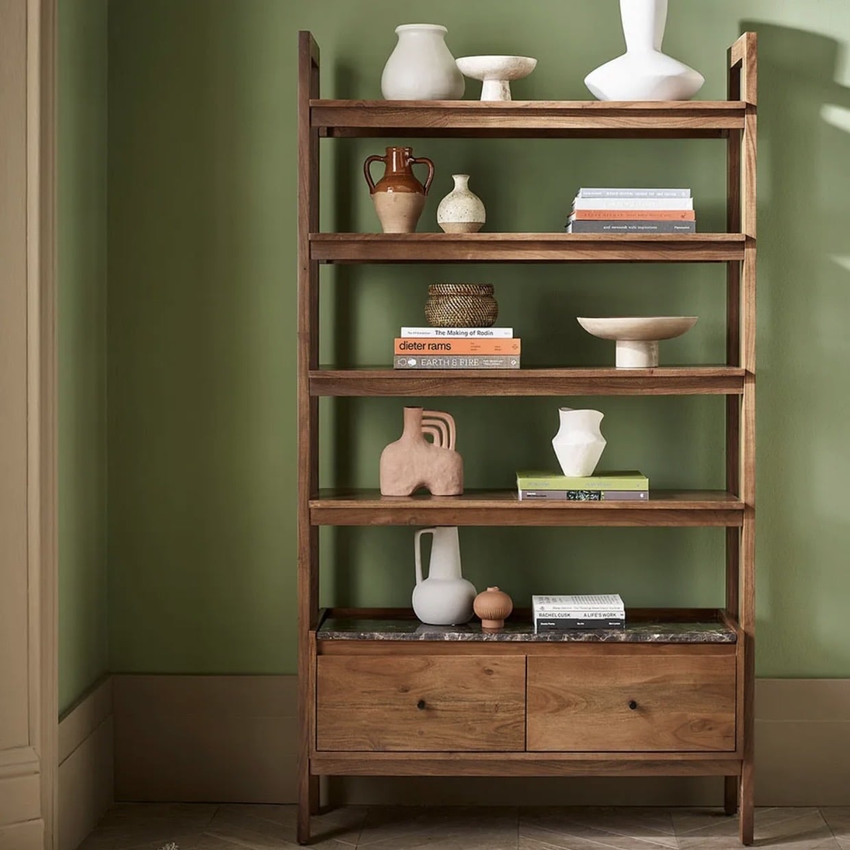 Walnut shelving unit for a pink and green living room