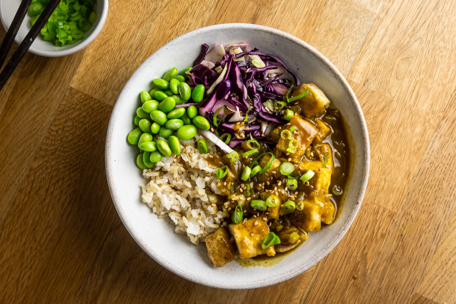 Tofu katsu curry bowl with crispy tofu cubes, rice, cabbage slaw and curry sauce