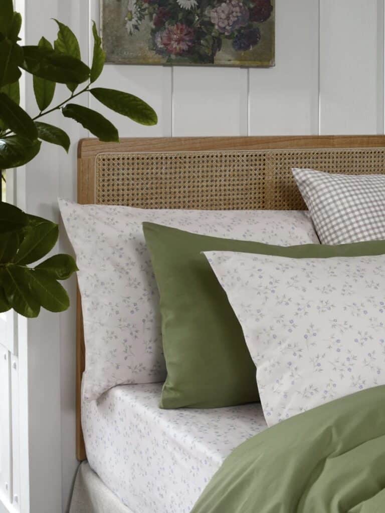 soft neutral cottage bedroom bedding with delicate floral linen pillowcases layered textures cosy cottage bedroom decor
