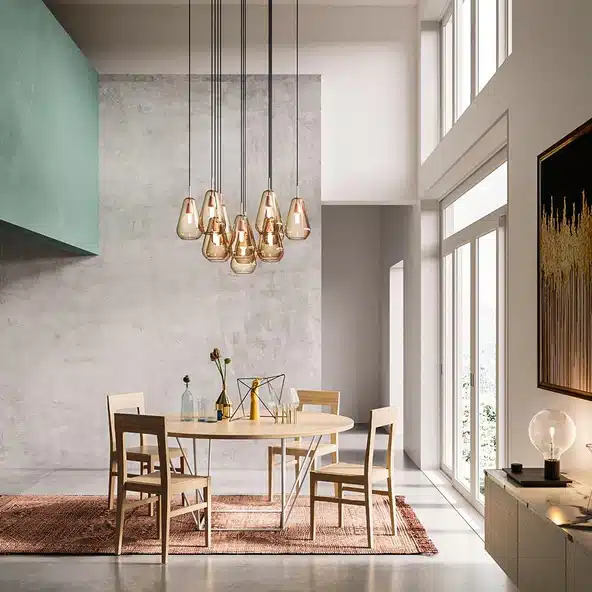 Nuura Anoli gold glass cluster pendant light over a round dining table in a contemporary dining room