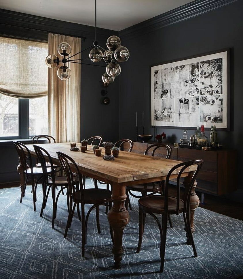 dark dining room with Farrow and Ball Down Pipe walls, bentwood chairs and sculptural globe pendant light