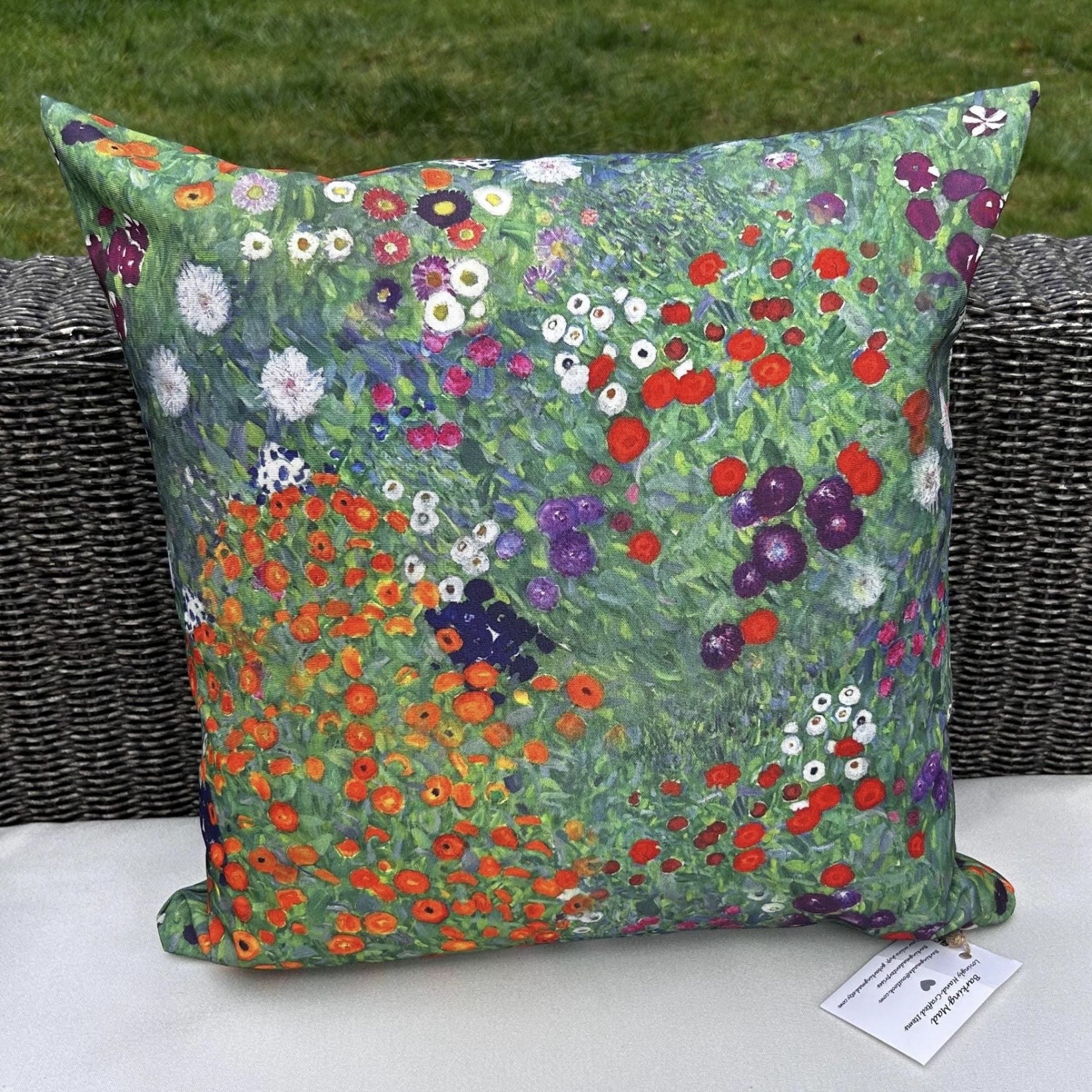 Outdoor cushion in Gustav Klimt Flower Garden print on rattan garden furniture by GoBarkingMad