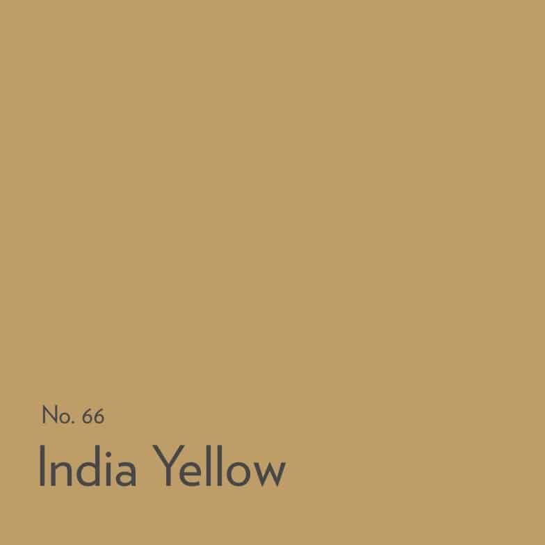 Warm yellow kitchen painted in Farrow & Ball India Yellow with dark worktops and rustic flooring