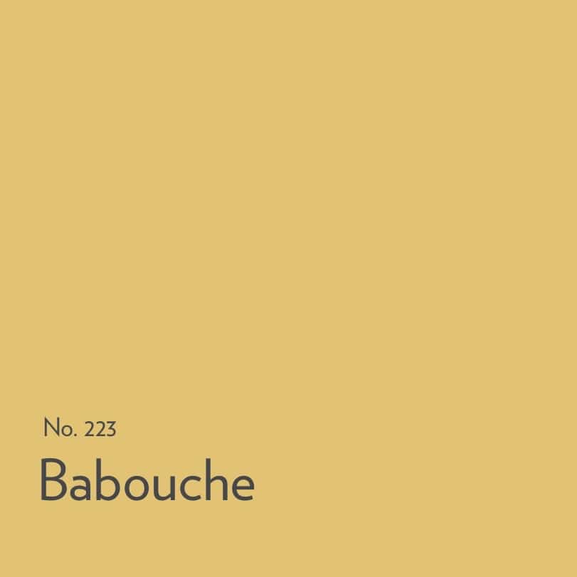 Bright yellow kitchen painted in Farrow & Ball Babouche with playful modern styling