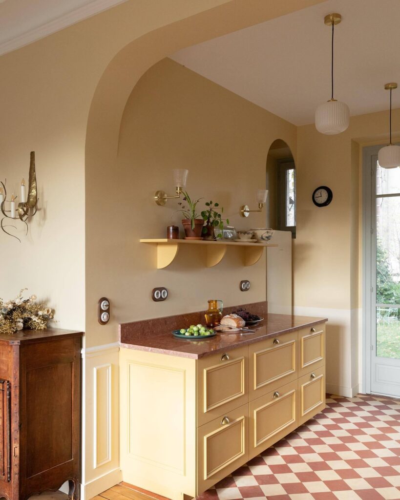 Cream and yellow kitchen with Farrow & Ball Dorset Cream and Sudbury Yellow cabinetry, chequered flooring and warm neutral walls