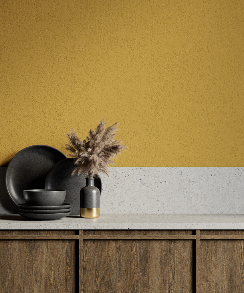 Mustard yellow kitchen wall with dark ceramics, textured paint and rustic wood cabinetry