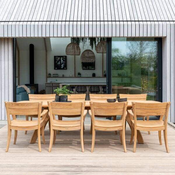 Alexander Rose Sorrento teak garden dining table and chairs on a decked terrace — outdoor dining furniture