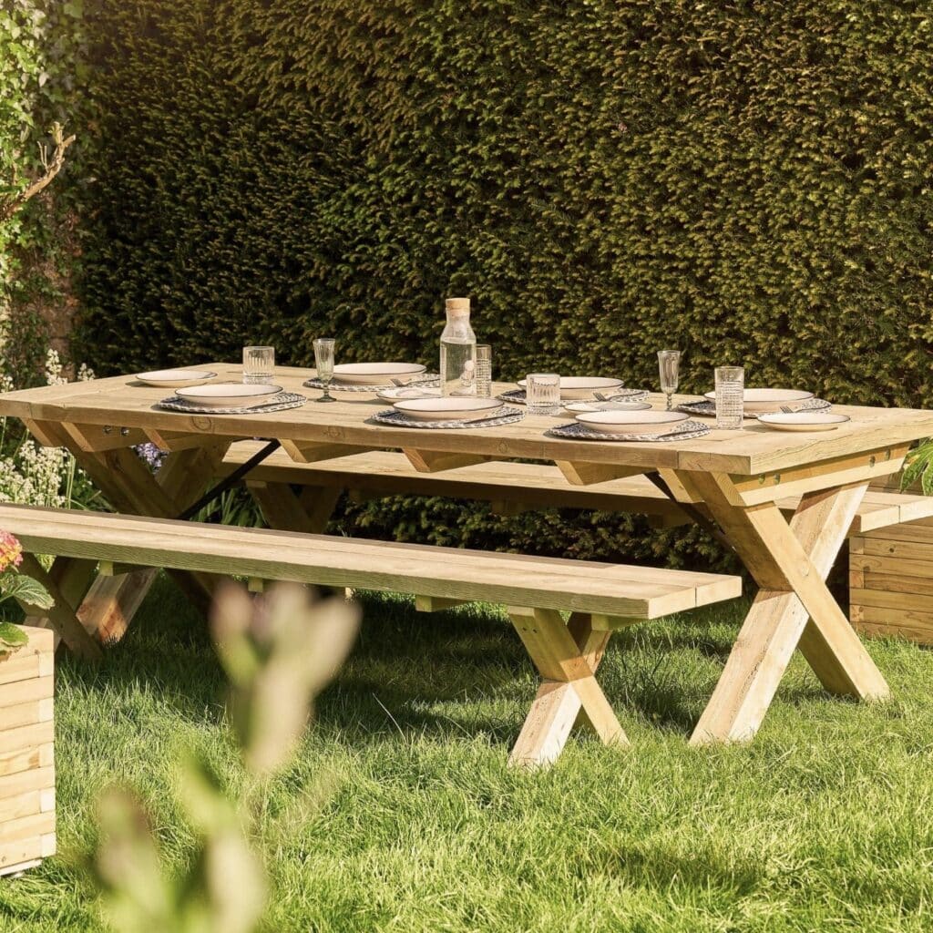 Rustic solid wood garden dining table and bench set styled with place settings