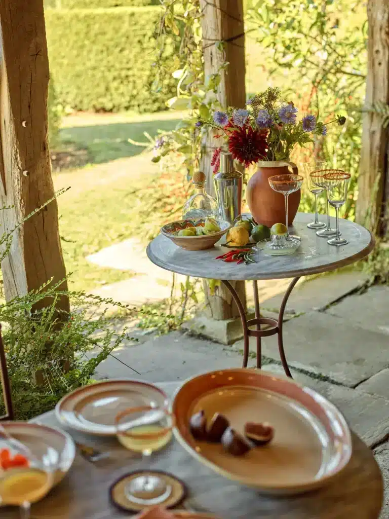 Rowen & Wren Sorrel Marble Bistro Table styled as an outdoor drinks table with flowers and glassware