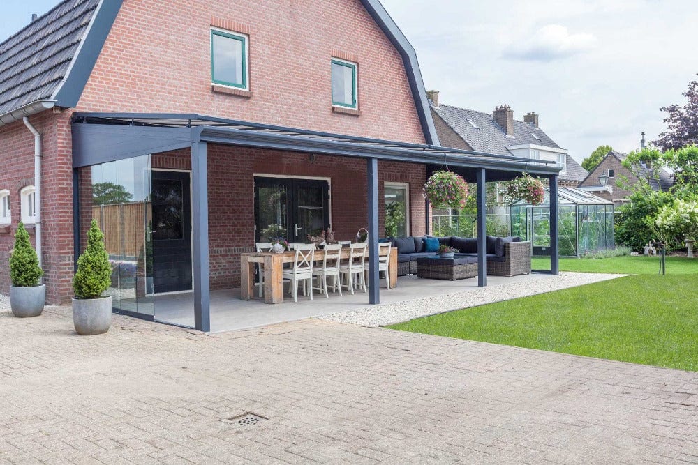 Covered aluminium veranda with outdoor dining table and chairs — garden dining area ideas