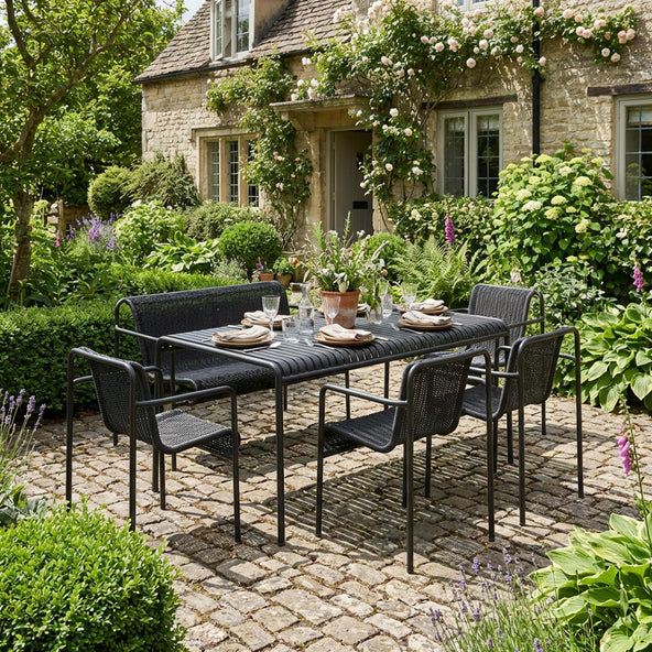 HAY Palissade Cord garden dining set in anthracite on a cobbled cottage garden terrace — outdoor dining ideas