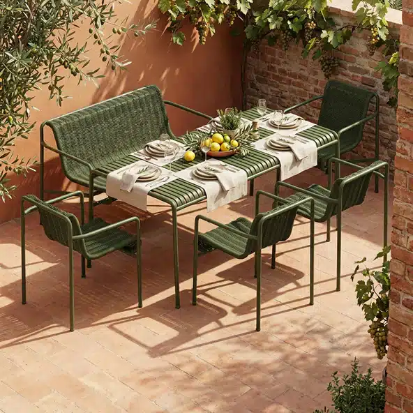HAY Palissade garden dining table and chairs in olive green on a decked terrace