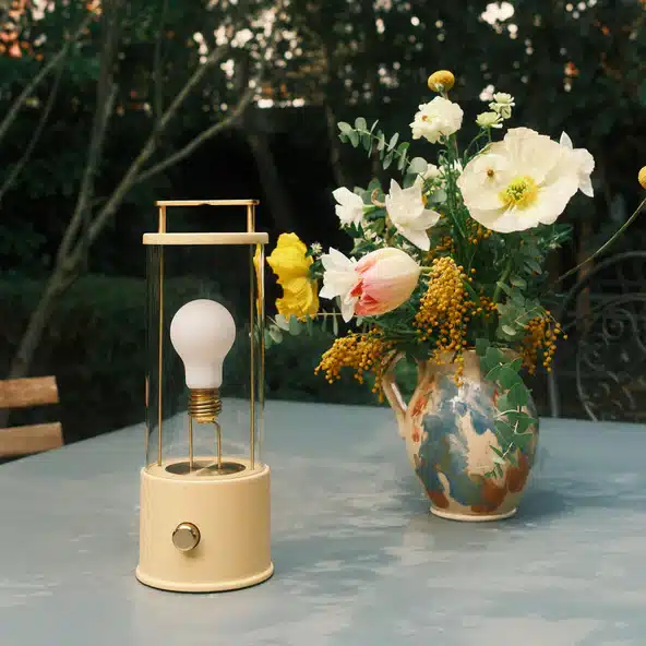  Tala The Muse portable rechargeable lamp on an outdoor dining table with garden flowers