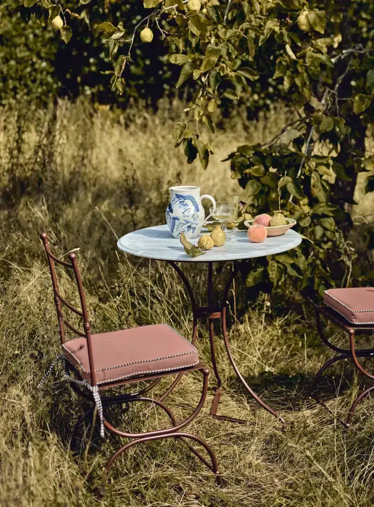 Rowen & Wren Sorrel Marble Bistro Table in a garden setting — small outdoor dining area ideas