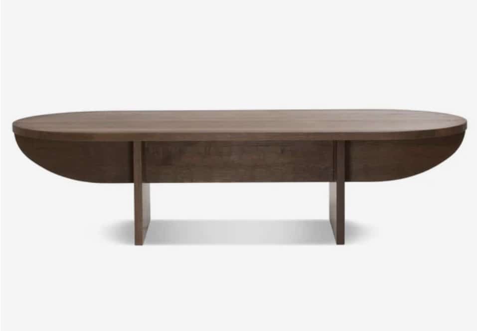 Bernstorffsminde Keel coffee table in soaped oak — sculptural half-moon silhouette for a tan leather sofa living room