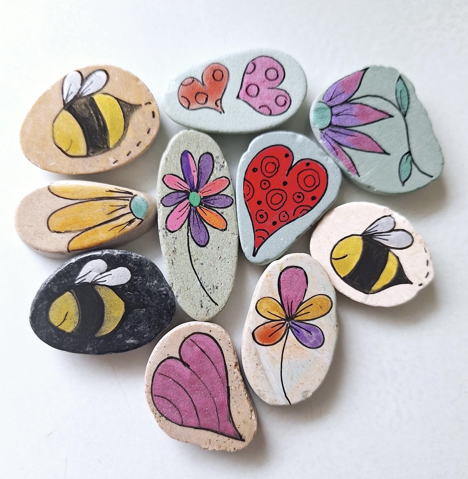 DIY painted rock kit for older children with flowers hearts and bees