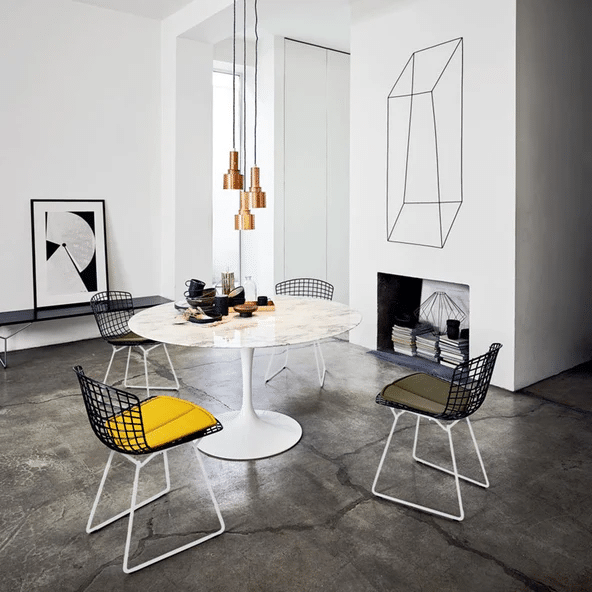 Knoll Saarinen round marble dining table with tulip base in a white dining room