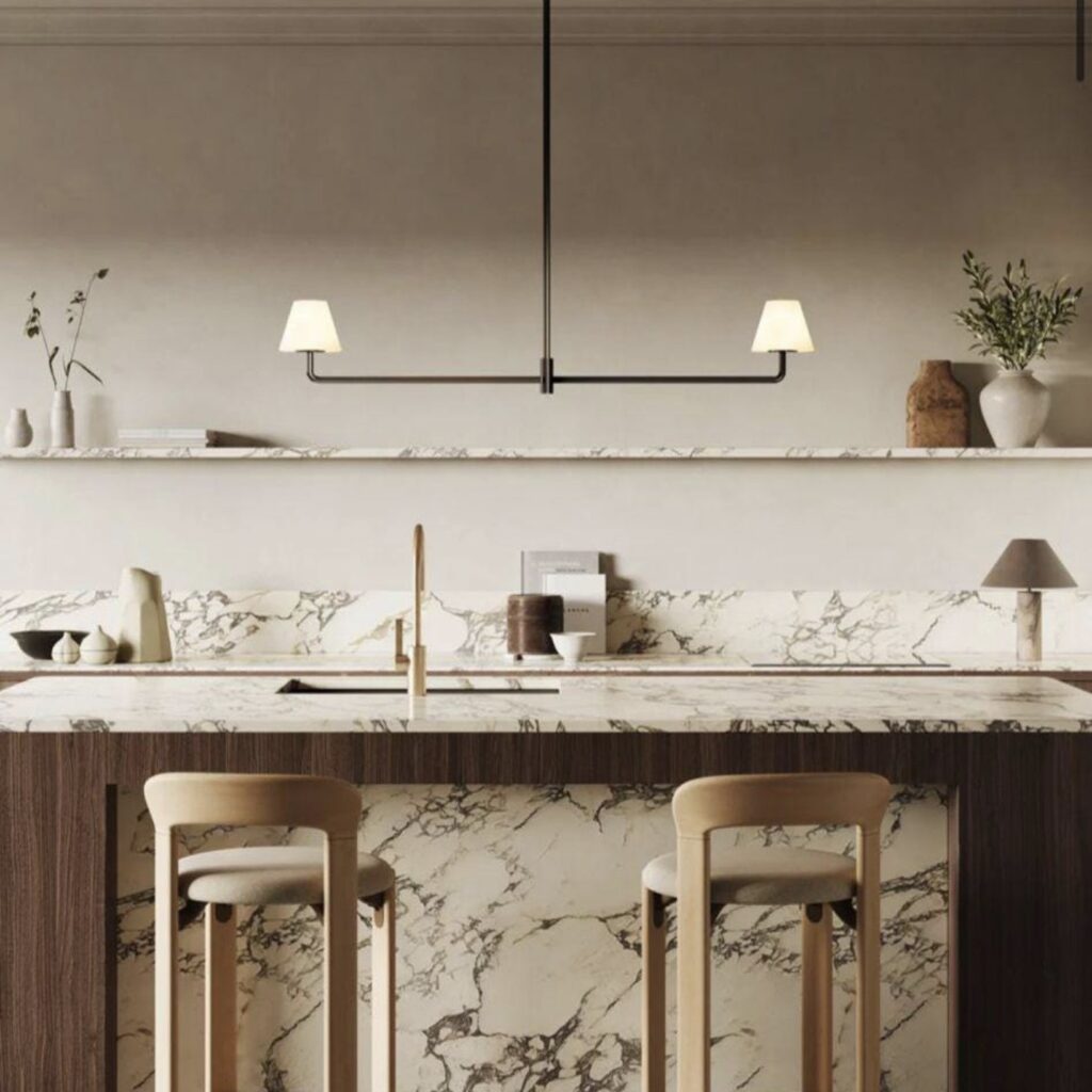 Sleek black linear pendant light with two fabric shades hanging above a marble kitchen island with bar stools