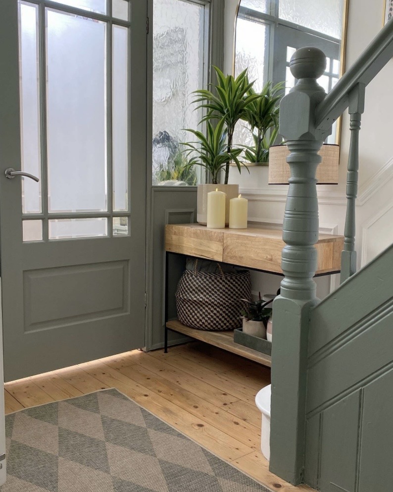 Card Room Green stairwell with patterned hallway runner and gallery wall