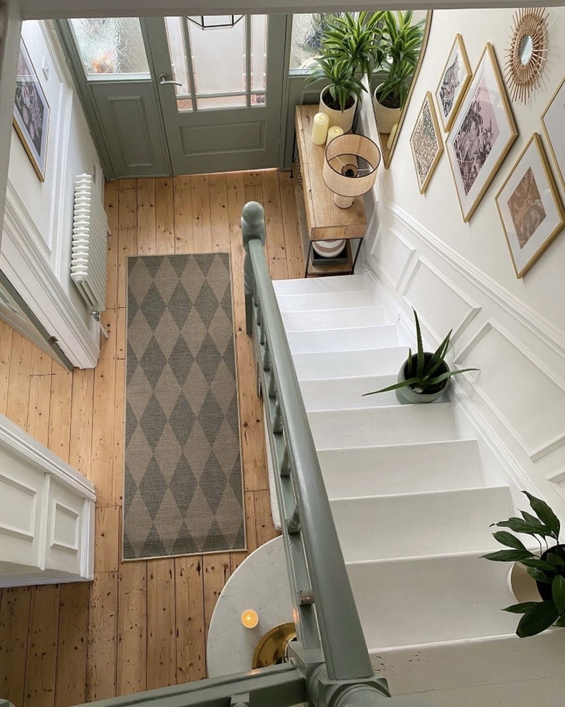 Card Room Green stairwell with patterned hallway runner and gallery wall
