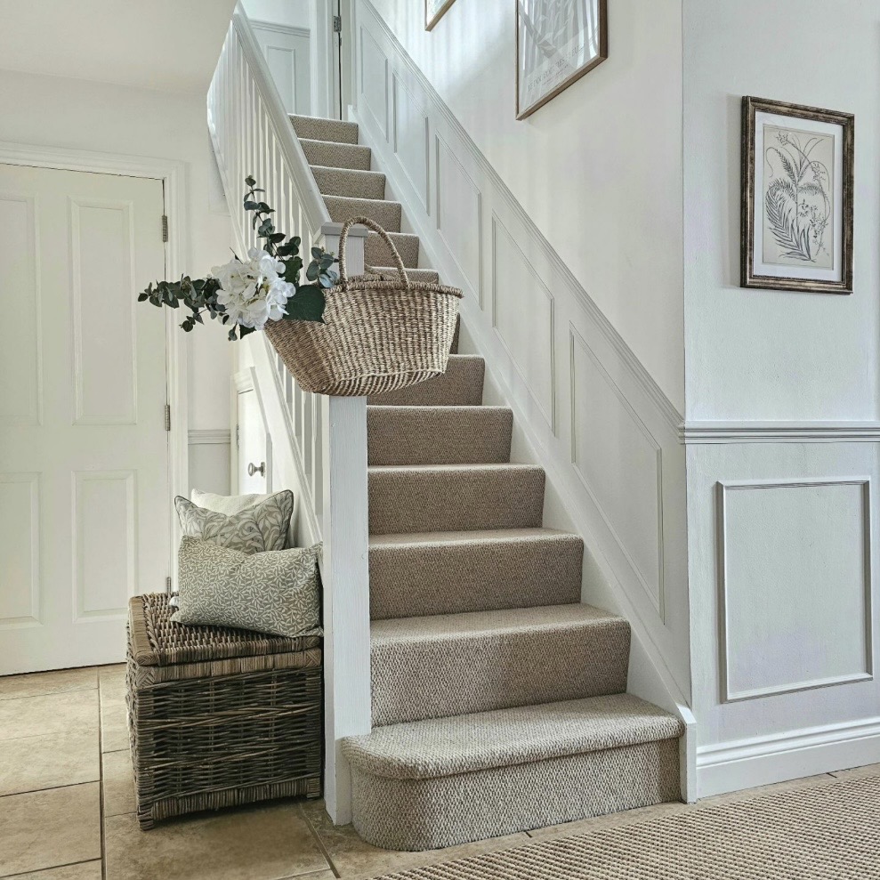 Staircase hallway with Ammonite wainscoting and striped stair runner